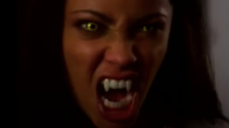 Teenage vampire showing fangs