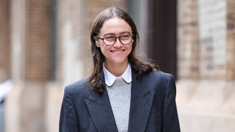 Ella Emhoff smiling in suit jacket and sweater