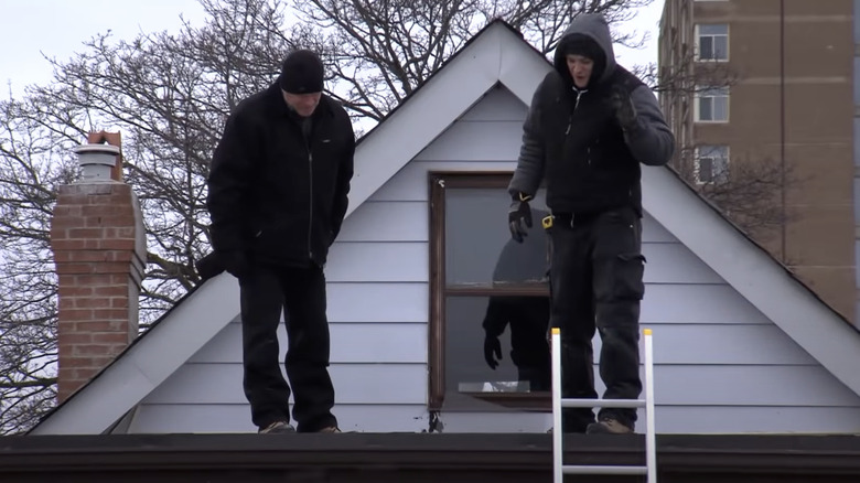 Mike Holmes and colleague on roof