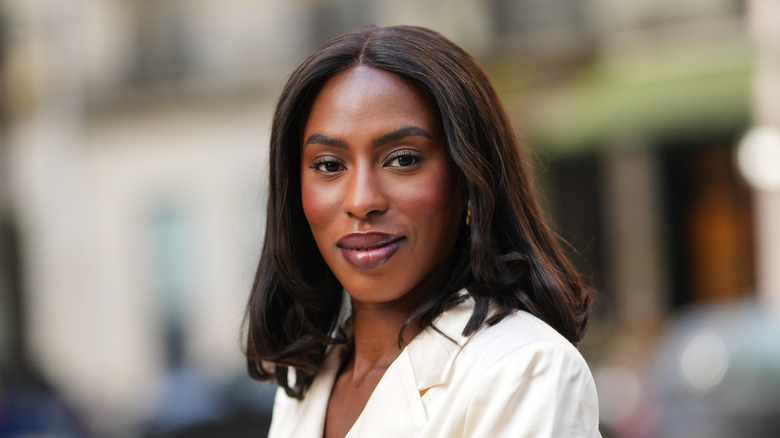 Closeup of woman in white blazer with shoulder-length hair