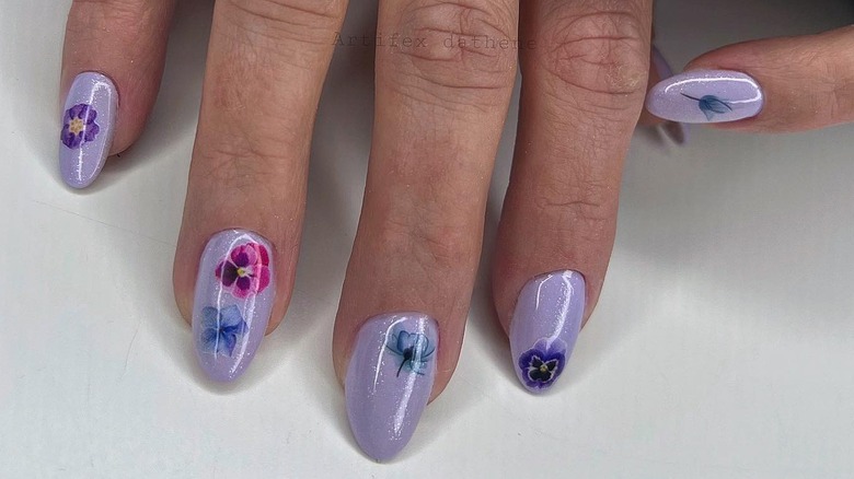 Purple nails with realistic flowers