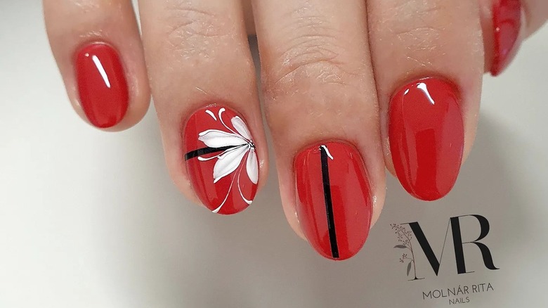 Red nails with white flower