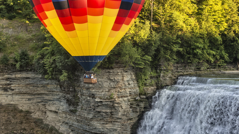 Hot air balloon flying over a waterfall at Letchworth State Park