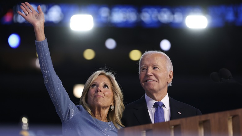 Jill Biden waving as Joe Biden smiles up at the crowd