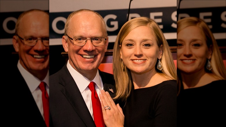 Chelsea Rose posing with her hand on husband John Rose's chest