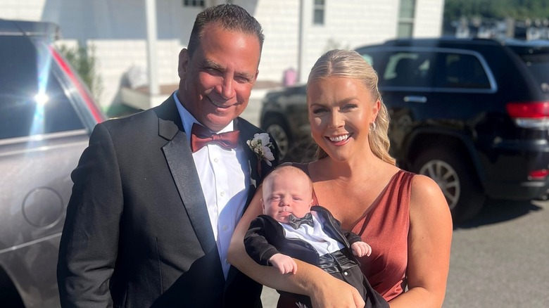 Karoline Leavitt, husband Nicholas Riccio, and their baby posing in wedding attire