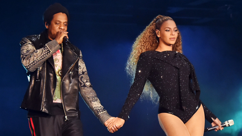 Jay-Z and Beyoncé holding hands while performing