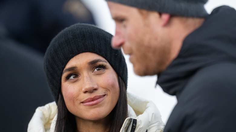 Meghan Markle looking up at Prince Harry who's talking