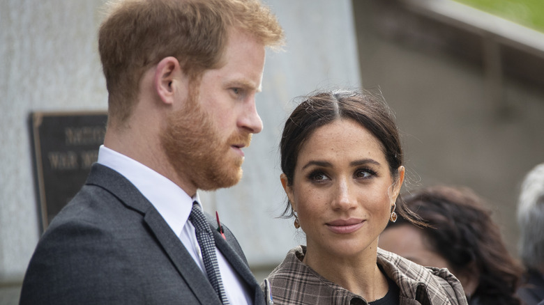 Meghan Markle looking up at Prince Harry who's talking