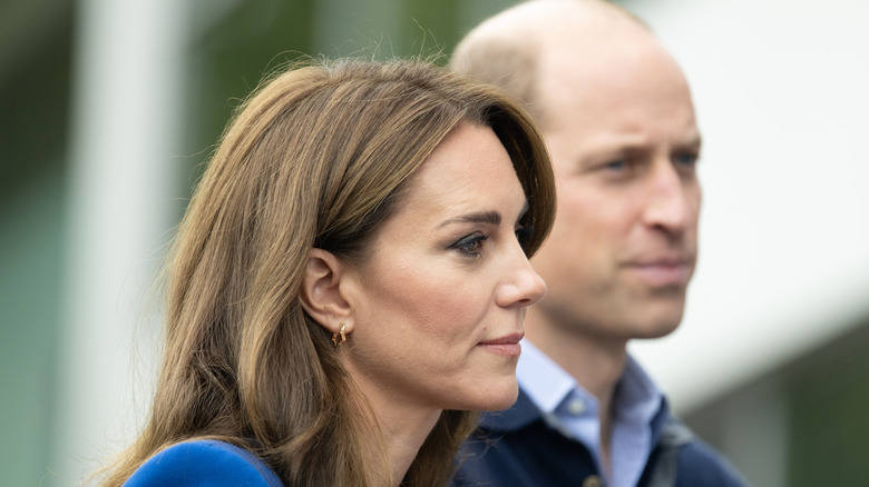 Closeup side profiles of Princess Catherine and Prince William standing next to each other