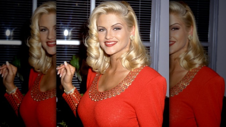 Anna Nicole Smith posing in red dress