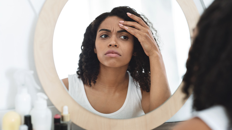 Black woman looking in the mirror