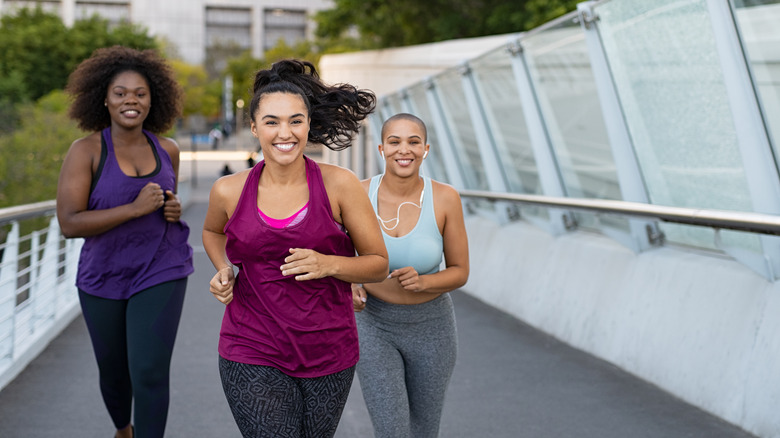 Three women running together