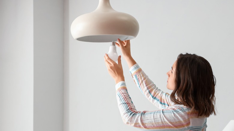 Woman changing a lightbulb