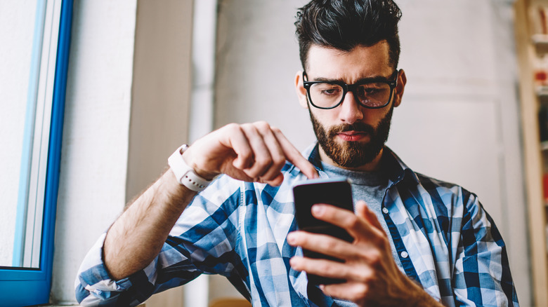 Man looking at phone screen