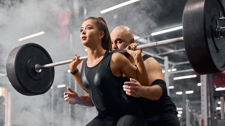 girl working out with a trainer