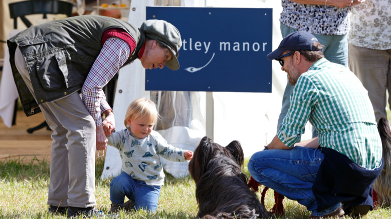 Princess Anne and Mia Tindall with a dog 