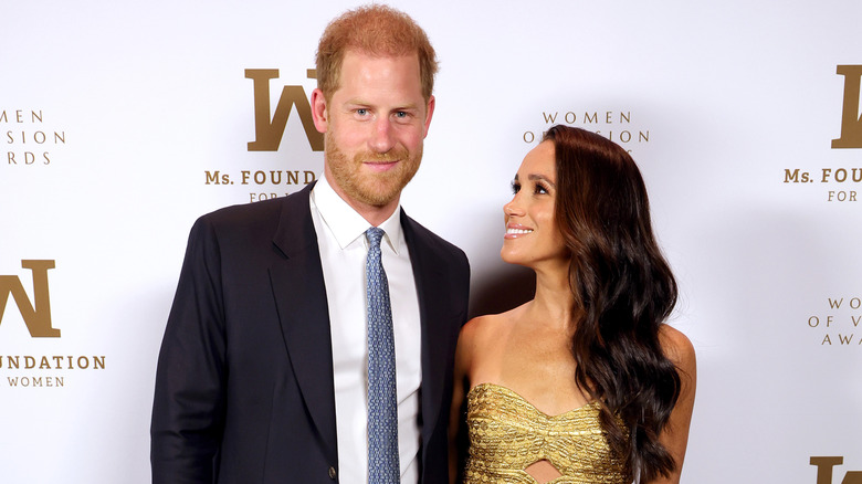 Meghan Markle looking at Prince Harry posing