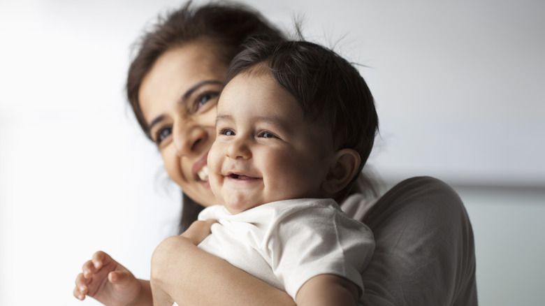 Woman holding smiling baby