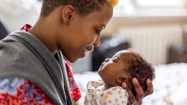 Woman holding newborn baby