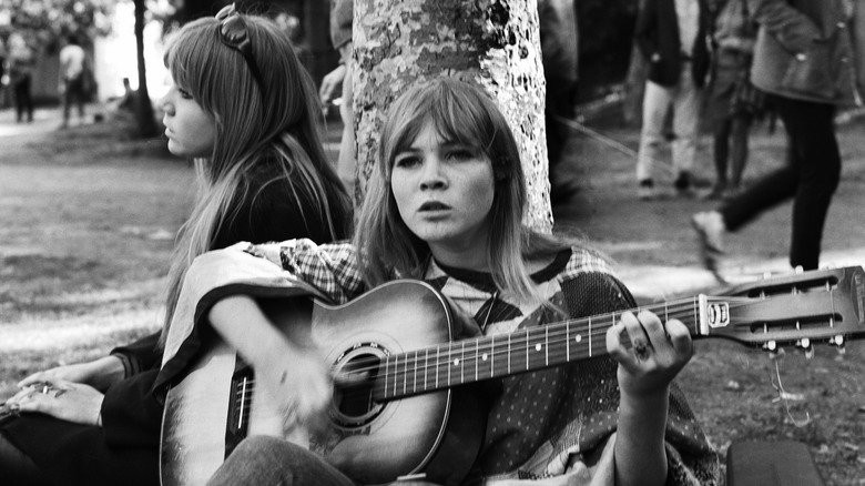 Girl sitting, playing guitar 1967