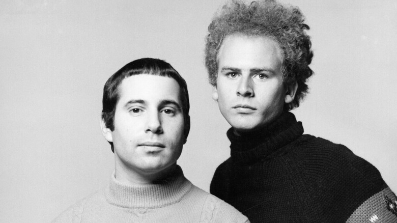 simon and garfunkel circa 1967. Both look at camera