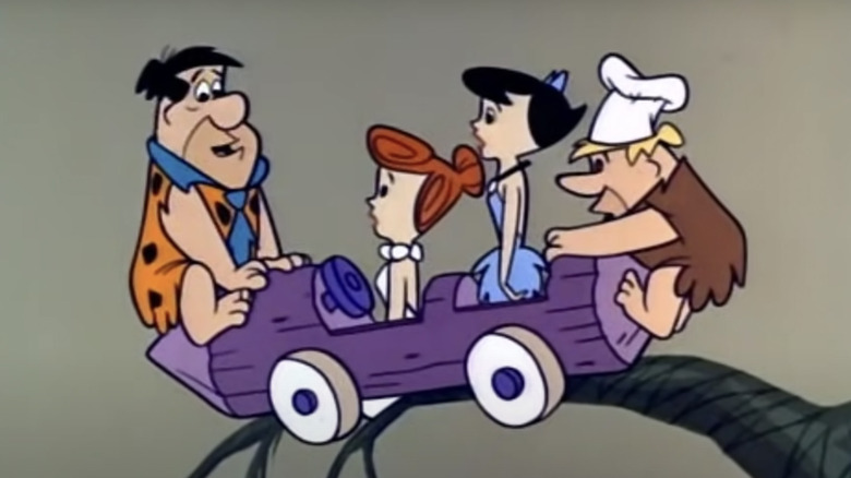 The Flintstones & rubbles hang precariously from branch