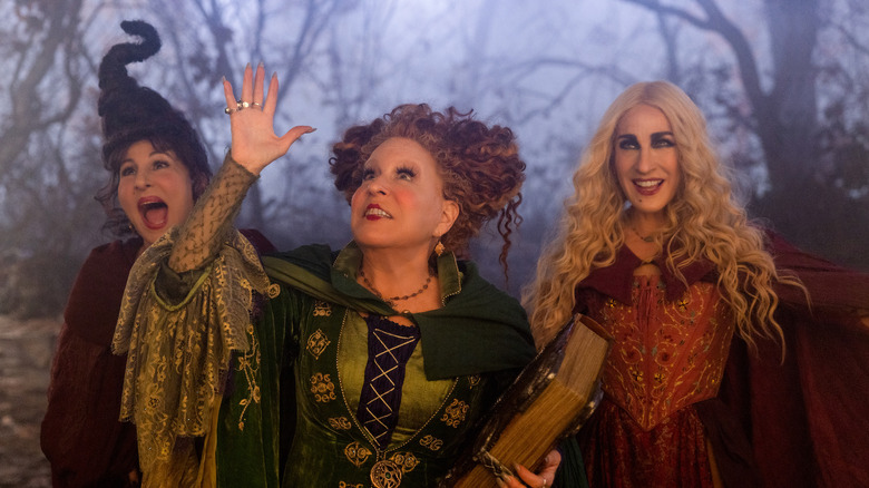 Sanderson sisters stand in the woods