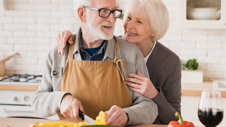 Elderly couple cooks together