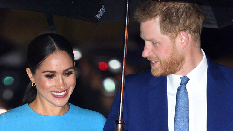 Meghan Markle and Prince Harry under umbrella