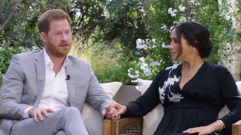 Prince Harry and Meghan Markle holding hands