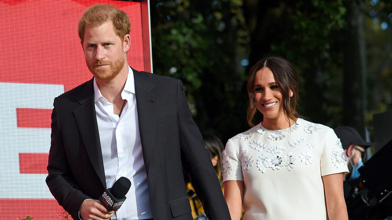 Prince Harry leading Meghan Markle