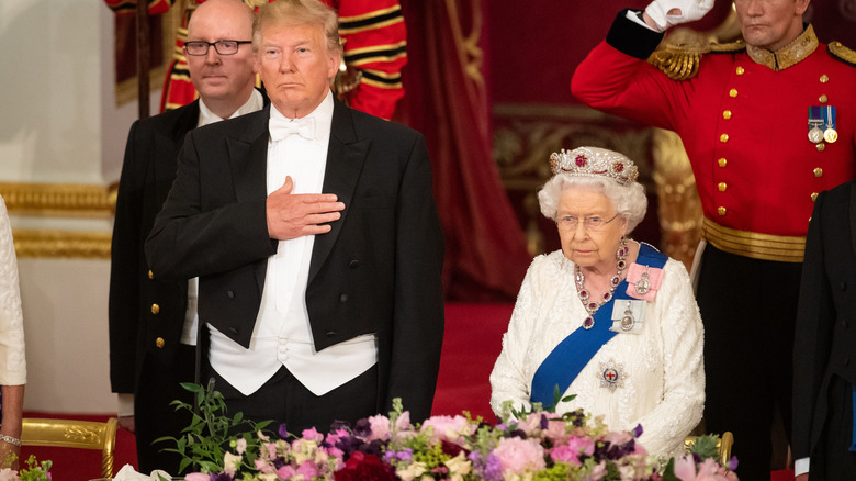 Donald Trump standing next to Queen Elizabeth II