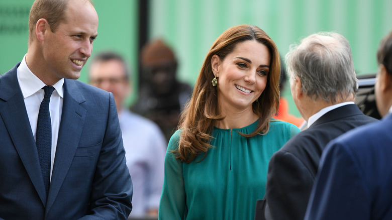 Prince William and Kate Middleton talking to man