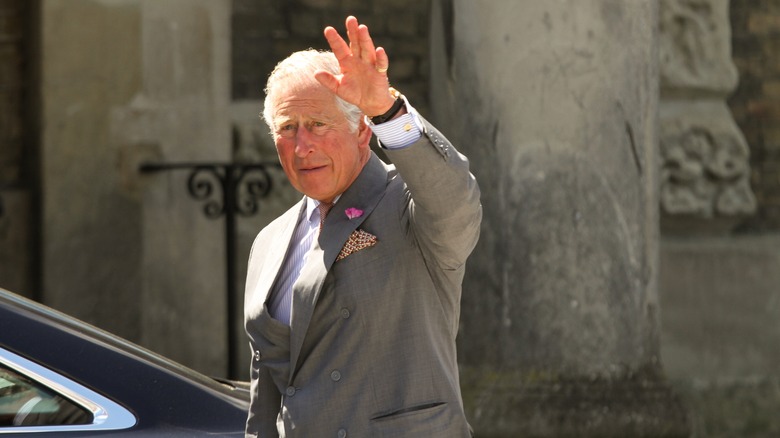 King Charles III waving at the camera