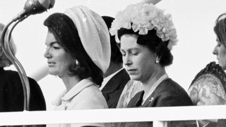 Jackie Kennedy and Queen Elizabeth II sitting next to each other