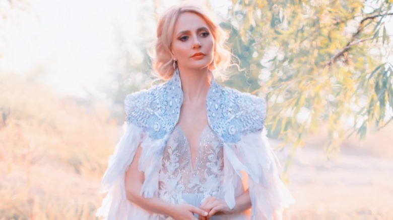 bride wearing light blue cape with stones