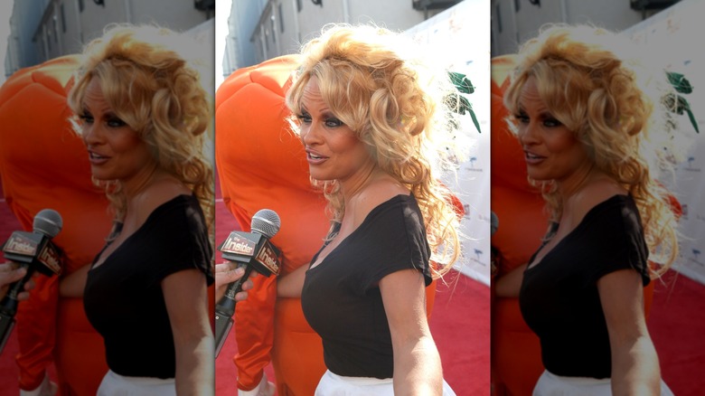 Pamela Anderson being interviewed on step-and-repeat at her Comedy Central Roast