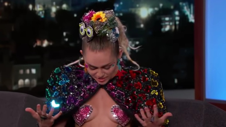 Miley Cyrus staring at bedazzled pasties