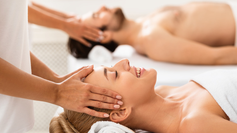 a couple getting their heads massaged