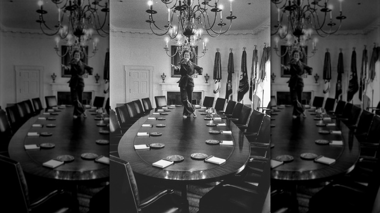 Betty Ford stands on a table