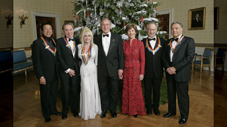 First lady Barbara Bush posing with her husband and guests