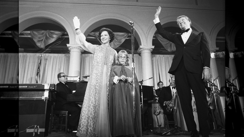 Rosalynn Carter waves with her husband and daughter