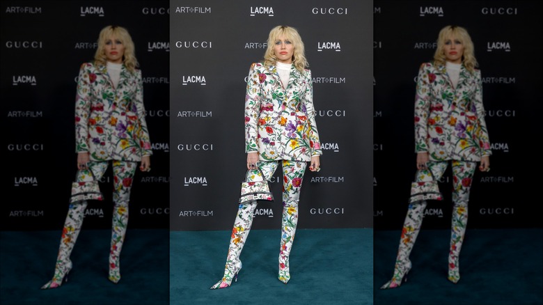 Miley Cyrus posing in floral suit