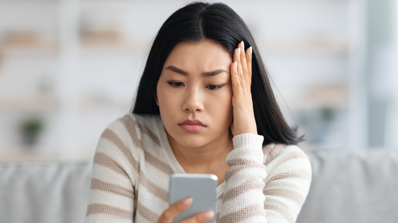 annoyed woman holding phone