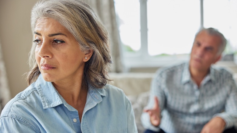 upset older man and woman on couch