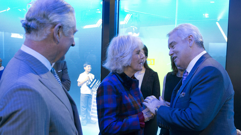 Camilla greeting man at event