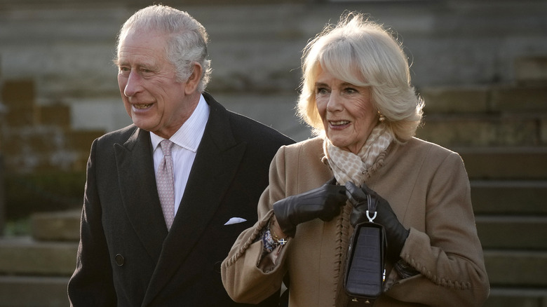 King Charles and Camilla walking outside