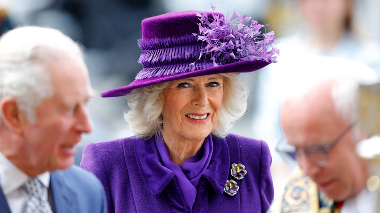 Camilla wearing purple hat and coat