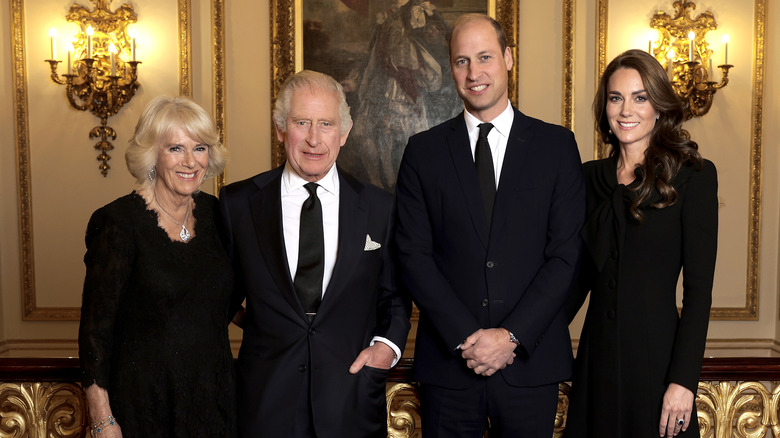 Camilla, Charles, William, and Catherine smiling for camera
